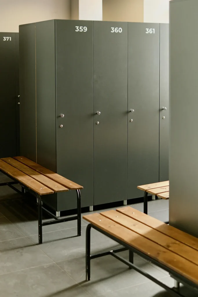 Best Sports Management Colleges: Numbered lockers and some benches in a locker room.