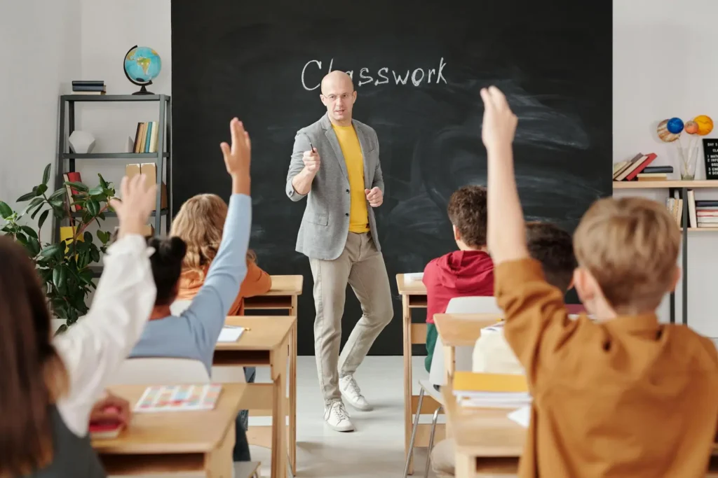 Do Middle School Grades Matter? A teacher standing in front of a room of students.