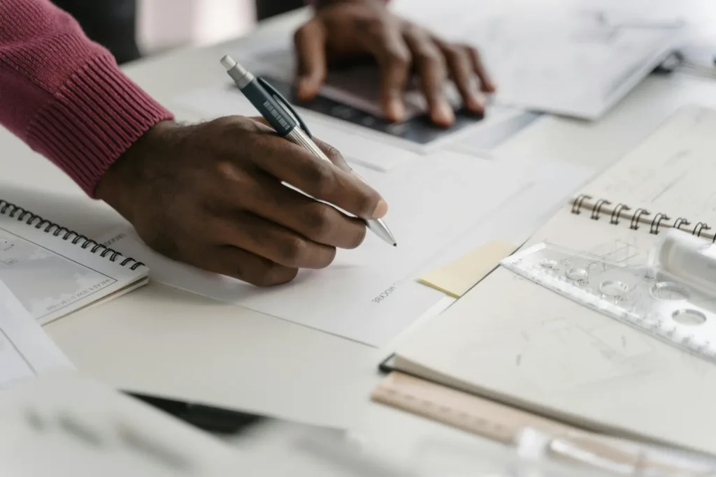 What Is The Hardest Engineering Major? A person leaning over a table with several papers on it.