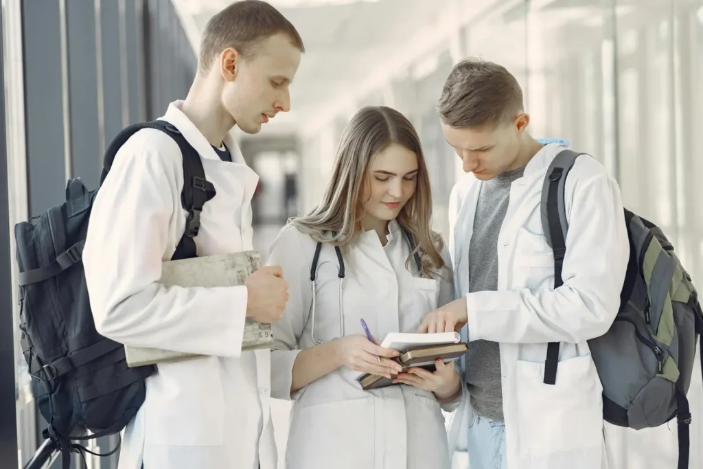How Long Does It Take To Become A Doctor? A group of medical students in a hallway.