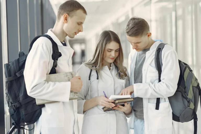 How Long Does It Take To Become A Doctor? A group of medical students in a hallway.