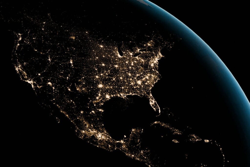 Sattelite image of North Ameirca at night with lights covering major metropolitan areas of the map
